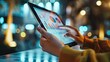 © ShakkBbo9495 - Close-up of a person analyzing data charts on a tablet