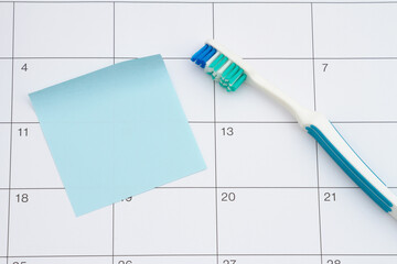 Wall Mural - Dental appointment with toothbrush and sticky note on a calendar