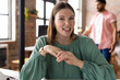 © Wavebreak Media - Caucasian female young professional sitting, smiling, wearing green top in a modern business office