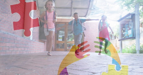 Wall Mural - Image of puzzles falling over ribbon formed with puzzles and school children running in school