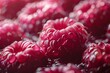 Vibrant close-up of ripe raspberries with a deep red color and fine dew droplets, beautifully illuminated to enhance texture and freshness.