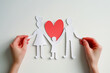 Hands holding paper family cutout on grey background, top view. Life and health Insurance concept