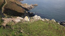 Drone Footage Of A Narrow Trail On A Coastal Rocky Cliff On A Sunny Day