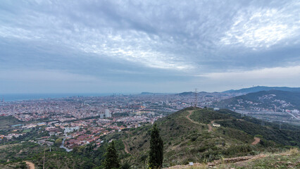 Wall Mural - Barcelona and Badalona skyline with roofs of houses and sea on the horizon day to night timelapse