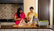 © Wavebreak Media - Indian mother and teenage daughter unpacking groceries at home