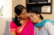 © Wavebreak Media - Indian mother and teenage daughter, sharing loving moment at home