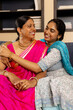 © Wavebreak Media - Indian mother and teenage daughter, sitting close at home, sharing happy moment