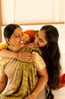 © Wavebreak Media - Indian mother and teenage daughter, embracing warmly, both showing joyful smiles
