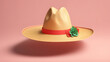 A straw hat with a red ribbon and a green flower on it