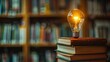 A stack of books with a light bulb glowing above, symbolizing knowledge and ideas
