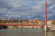 Saone river and pedestrian bridge in lyon, with Croix-Rousse hill in background