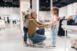 Father Engaging With Daughters During Shopping Trip in Clothing Store