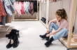 Young Girl Trying On Shoes in a Brightly Lit Clothing Store