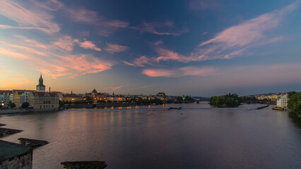 Wall Mural - View from Charles Bridge in Prague before the sunrise night to day timelapse, Bohemia, Czech Republic.