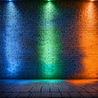 a neon lighting effect with vibrant green, orange, and blue colors, set against the textured backdrop of bare brick walls. The illustration should convey a feeling of urban nightlife, with the neon li