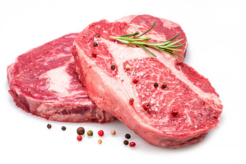 Wall Mural - Raw ribeye steaks with pepper corns and rosemary isolated on white background.