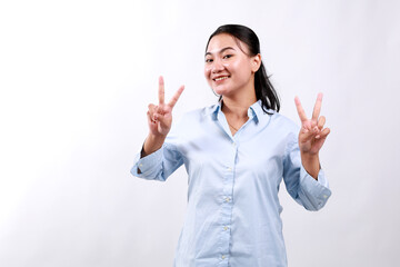 Positive charming asian woman showing victory peace signs look up happily smile enjoy celebration, white background