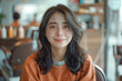 © S photographer - Asian woman sitting in a barber chair in a beauty salon.