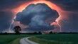 A breathtaking landscape dominated by a massive, dark storm cloud that seems to be swirling and rising. The cloud is illuminated by a fiery orange and red glow, possibly from the setting or rising sun