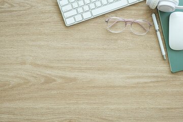Wall Mural - Top view of keyboard, coffee cup and stationery on wood working desk.