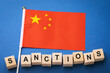 Chinese flag and wooden cubes with text, concept on the theme of sanctions in China