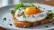A plate of food with a fried egg on top of a piece of toast