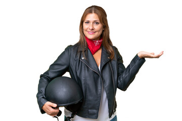 Canvas Print - Middle-aged caucasian woman with a motorcycle helmet over isolated background extending hands to the side for inviting to come