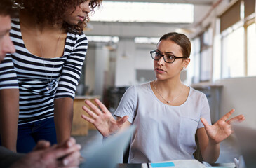 Canvas Print - Woman, business and staff in office for meeting with manager as graphic designers for customer feedback. Female person, people and teamwork for creative company with documents for project proposal