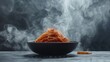 Pasta, spaghetti with tomato sauce in black bowl. Grey stone background., on dark Background with smoke and steam, view.
