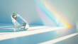 Crystal prism refracting light into a rainbow on a white surface.
