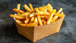 Delicious and appetizing French fries in a cardboard package
