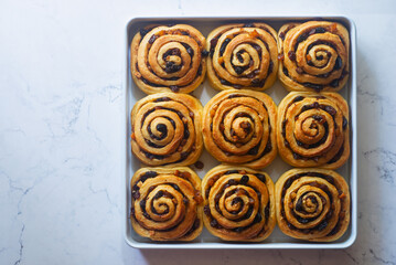 Wall Mural - close up Freshly baked mixed fruit cinnamon rolls in a baking tray