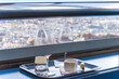 Empty bottle and wineglasses on a tray in restaurant in Montparnass tower with view for paris