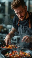 Wall Mural - b'Focused male chef cooking in a restaurant kitchen'