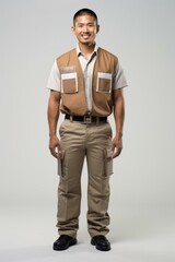 Wall Mural - b'Asian man wearing a brown vest and khaki pants'