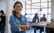 © Peopleimages - AI - Crossed arms, happy and portrait of business woman in office with positive, good and confident attitude. Smile, pride and Asian graphic designer with creative career in startup workplace in New York.