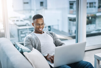 Poster - Black man, couch and home with laptop for relax, watching movies and streaming app. African male person, tech and living room in apartment with social media for day off, online subscription and rest