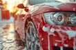 Professional red car wash with shampoo foam and water splashes, auto detailing service