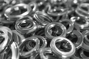 Poster - A pile of metal rings stacked on top of each other. Great for industrial or manufacturing concepts
