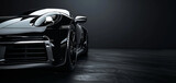 Fototapeta  - Front view of a modern hybrid black car close up on a black background