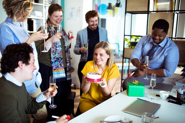 Canvas Print - Office birthday celebration with colleagues enjoying cake and champagne