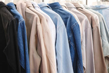 Poster - A rack of clothes with a variety of colors and patterns