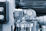 Fototapeta  - A close up of a pressure gauge on a machine, industrial concept background