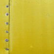Vintage metallic board. Yellow color template frame, old metal door surface with screws.