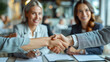 © aekkorn - Young business people meeting office handshake hand shake shaking hands teamwork group contract signing agreement document signature paperwork success corporate senior mature.