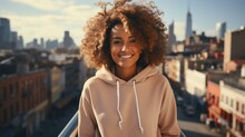 B'Smiling Woman With Curly Hair Standing On A Rooftop In An Urban Setting'