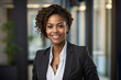 The business girl , an African American , is smiling . Portrait