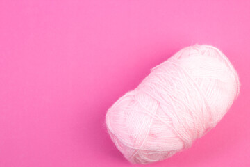Wall Mural - Knitting yarn for knitting on pink background. white.