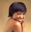 Short hair, beauty or portrait of happy black woman in studio for keratin growth, healthy shine or wellness. Model, shampoo cosmetics or face of girl with natural texture or glow on brown background