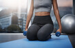 © peopleimages.com - Fitness, girl and dumbbells at home for workout, yoga and exercise on mat in apartment. Female athlete, pilates and training for health, wellness and muscle strength or arms with endurance in sports